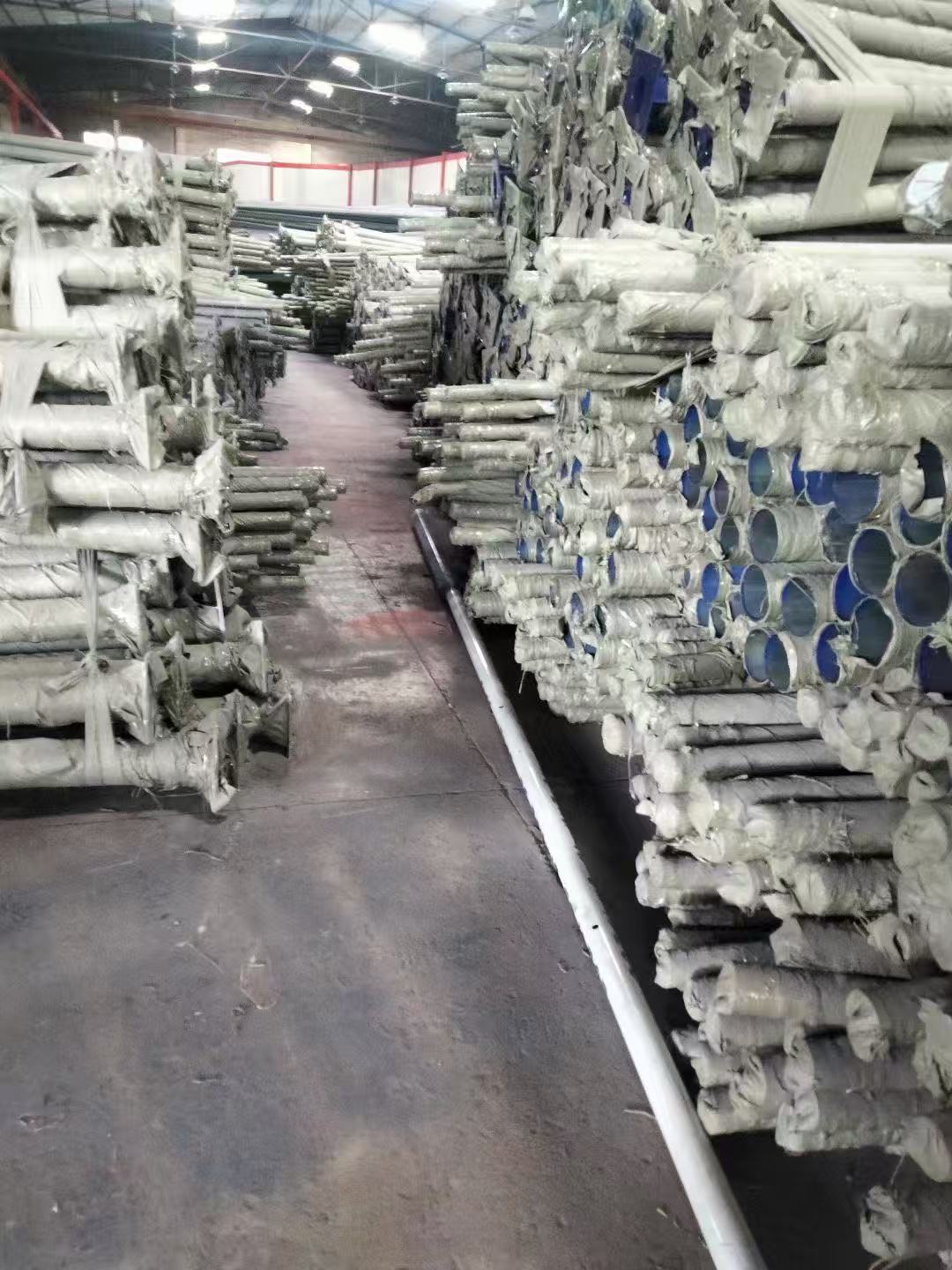 Racks of galvanized and wrapped steel poles stored inside the WILSOLAR pole warehouse in Zhongshan, Guangdong