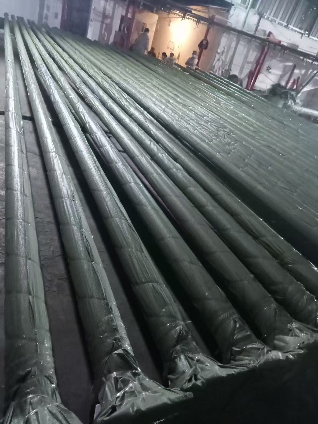 Long steel poles wrapped in protective film and racked after coating at WILSOLAR's Zhongshan factory